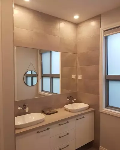 Bathroom vanity with downlights, mirror, windows and wall switches